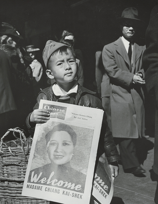 [boy holding issue of Chinese Press welcoming Madame Chiang Kai-shek]