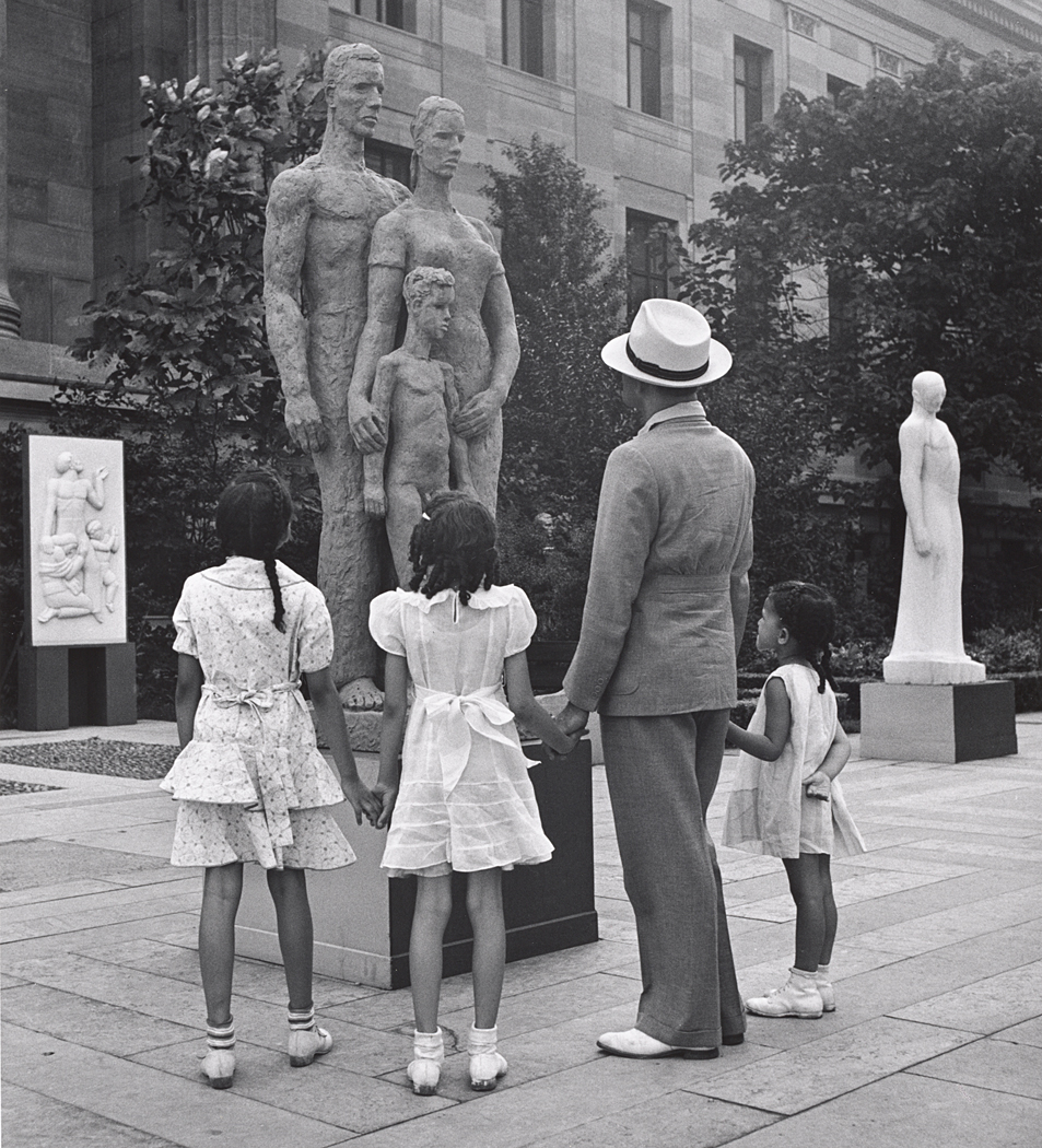 Black Man with Three Little Daughters Looking at Sculpture